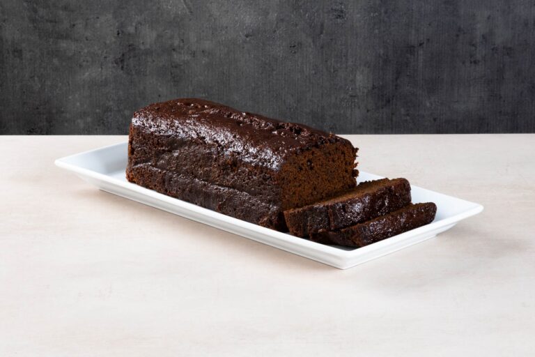 Sliced coffee loaf cake with buttercream and chocolate buttons